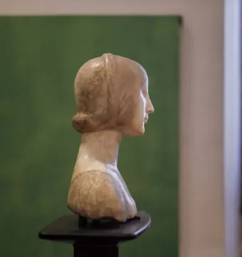 Portrait of Eleanor of Aragon, a light stone bust shown in profile facing right with a covered head
