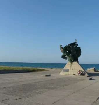 Bronze Monument of Eupatoria Assault on a concrete pedestal near the sea.