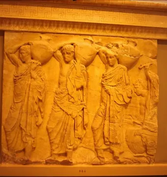 Parthenon metope stone relief with draped figures carrying large vessels
