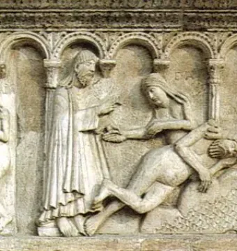 Stone relief by Wiligelmo showing several scenes with robed figures and nude human figures divided into arched panels.