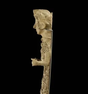 Lady of Ibiza sculpture showing a standing female figure in profile with an elaborate headdress and decorated attire.