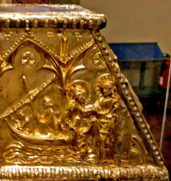 Gilded relief on the Sant Cugat Casket showing figures in a boat, standing figures, and gothic arches.