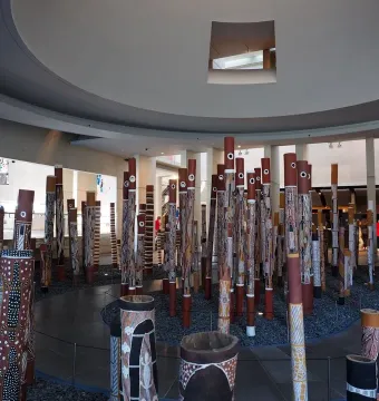 Aboriginal Memorial installation of painted vertical poles in a gallery space