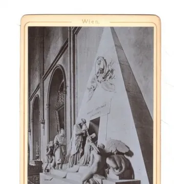 Cenotaph of Archduchess Maria Christina with draped figures, children, and a portrait medallion in a vaulted interior.