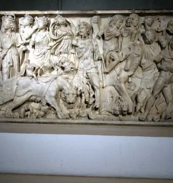 Roman marble relief on the Sarcophagus of the Triumph of Bacchus, showing a crowded scene with draped and partially nude figures and large felines.