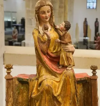 Virgin on a Wide Throne wooden sculpture showing a seated robed woman with a child on her lap