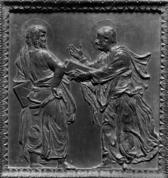 Bronze relief panel from Donatello’s Door of the Apostles showing two haloed men in drapery, one holding a book and facing the other with an open hand.