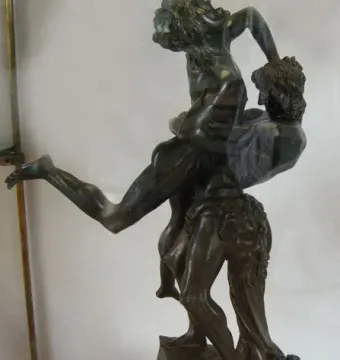 Hercules and Antaeus bronze sculpture showing two muscular figures in a struggle on a marble pedestal.