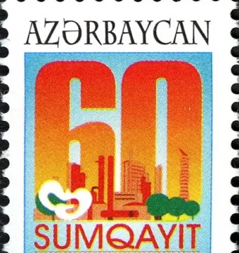 Peace Dove emblem on an Azerbaijani postage stamp with a large 60 and an urban background.