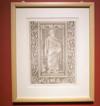 Framed monochrome print showing a bearded haloed figure surrounded by decorative panels and a narrative frieze from the Filarete Door.