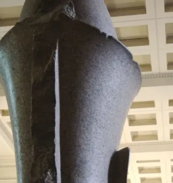 Colossal Head of Amenhotep III seen from below, showing the back of the stone sculpture and a partial ear.