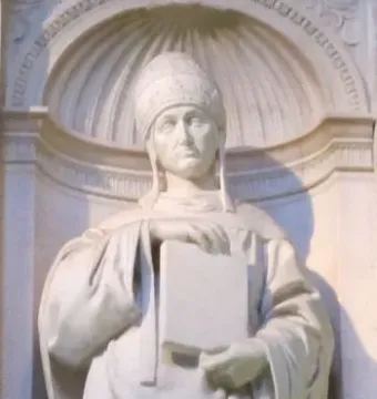 Saint Gregory marble statue holding a book, set in a sculpted niche with a shell-like dome.