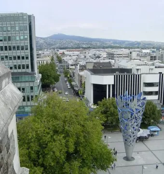 The Chalice stands in a tiled public square with buildings and trees around it, seen from above.