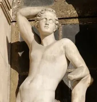 Apollino, a nude young male statue with one arm raised and a quiver beside him.