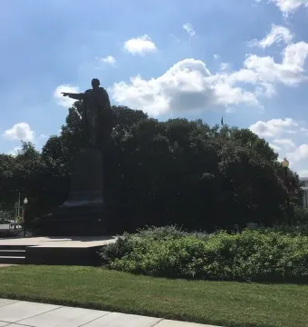 Benito Juarez statue standing on a pedestal with his right arm extended and pointing forward.