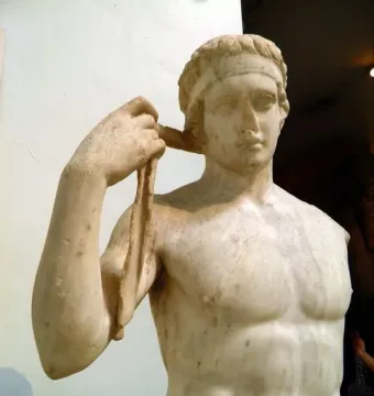 Farnese Diadumenos marble statue of a young athlete tying a ribbon around his head.