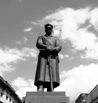 Józef Piłsudski Monument showing a military figure on a granite pedestal with an engraved name and national emblems.
