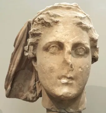 Lycosoura Demeter stone head with worn facial features and a draped veil-like covering