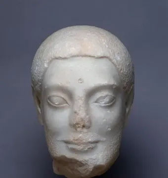Sabouroff Head sculpture of a male head in white stone with delicate features and textured hair.