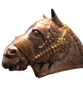 Sassanian horse head sculpture with ornate metal detailing, shown in profile facing left.