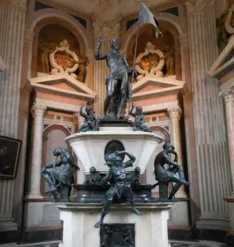 Mausoleum of Prince Ernst with a marble and bronze resurrection monument featuring a standing male figure holding a flag, surrounded by smaller figures.