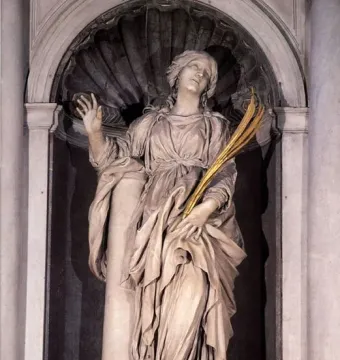 St Bibiana by Bernini, a marble statue of a woman in a shell-topped niche, gazing upward with one hand raised and holding golden fronds.