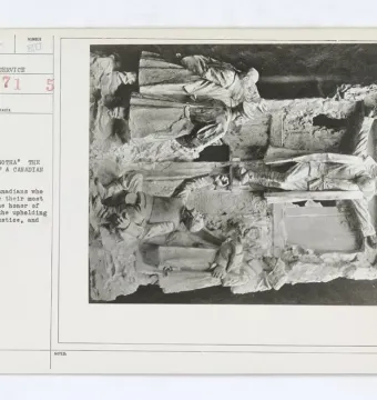 Archival photograph of a document card beside an angled relief sculpture from Canada\'s Golgotha, showing soldiers in a commemorative scene.
