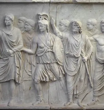 Cancelleria Reliefs showing a classical Roman procession carved in pale marble with robed figures and a helmeted woman among them.
