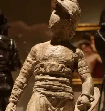 The Gladiators terracotta figure wearing a helmet and holding a small shield