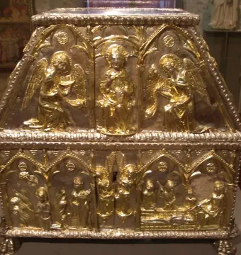 Sant Cugat Casket with gilded figures and arched scenes on a silver-colored metal casket