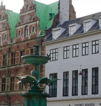 Stork Fountain with three bird sculptures and cascading water in Copenhagen.