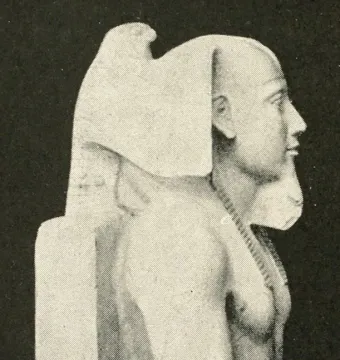Right profile of the Khafre Enthroned statue, showing the pharaoh with a nemes headdress, false beard, and beaded necklace.