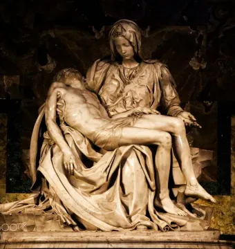 Pietà marble sculpture of Mary cradling the body of Jesus across her lap