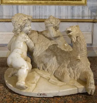 The Goat Amalthea sculpture showing two plump child figures with a shaggy goat, one kneeling on its back and another covering its eyes.