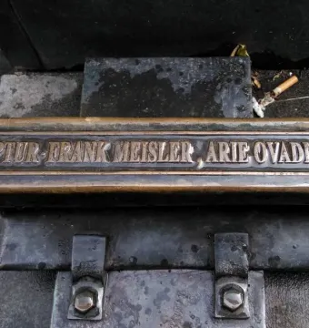 Close-up of the inscription plaque on Trains to Life – Trains to Death