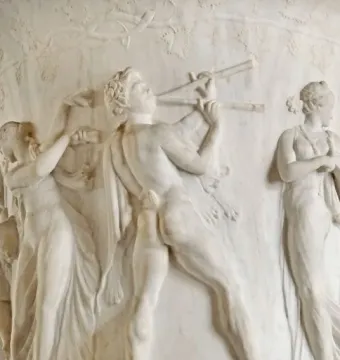 Borghese Vase relief with a satyr playing a double flute between two draped women