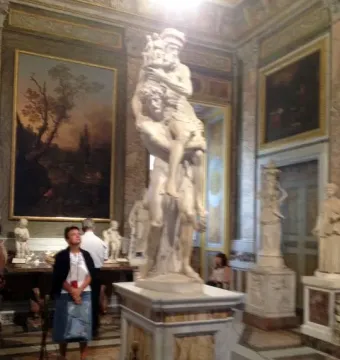 A marble sculpture of Aeneas, Anchises and Ascanius showing a man carrying an older man while a child clings to his leg.