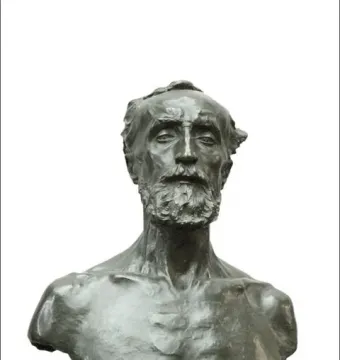 Bronze bust of Jules Dalou with a serious expression on a dark stone base.
