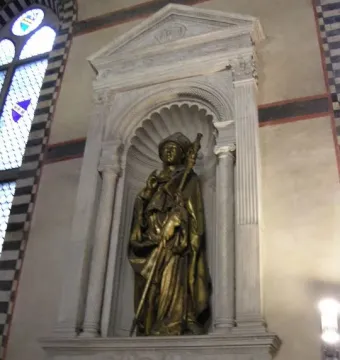 Saint Louis of Toulouse statue in an ornate stone niche with columns and a pediment.