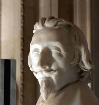 White marble bust of Cardinal Richelieu with a mustache, pointed goatee, and wavy shoulder-length hair.