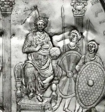 Relief from the Disc of Theodosius showing an enthroned ruler holding an orb, flanked by attendants and columns.