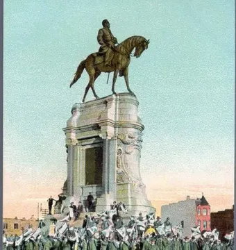 Robert E. Lee Monument with a large crowd gathered below, many holding flags.