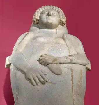 Lady of Cádiz reclining stone sculpture with carved hair and folded hands