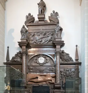 Tomb of Lew Sapieha, a tall ornate marble monument with carved figures, relief panels, and a standing figure at the top
