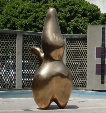 Cloud Shepherd bronze abstract sculpture with smooth organic contours on a tiled outdoor plaza.