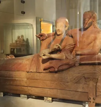 Sarcophagus of the Spouses terracotta sculpture of a reclining married couple in a museum display case.