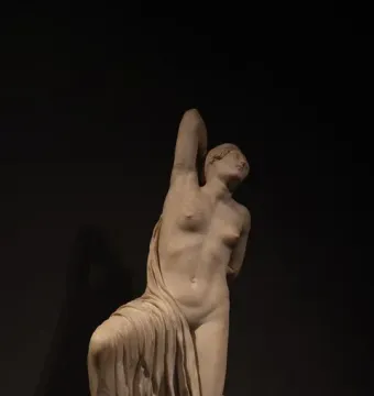 Niobid from the Gardens of Sallust, a marble sculpture of a kneeling female figure with one arm raised above her head.
