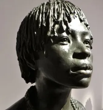 Woman of Central Africa bronze sculpture with textured hair and beaded necklaces in three-quarter view
