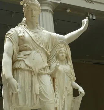 Hope Dionysus, a white marble statue of a standing male figure with a wreath and raised arm, leaning beside a veiled female figure.