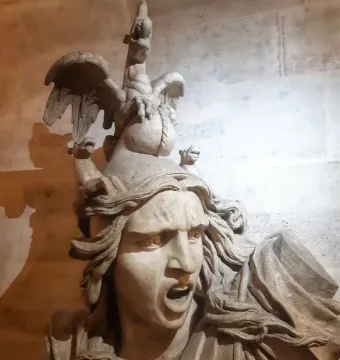 La Marseillaise sculpture showing a shouting armored figure with flowing hair and a winged rooster above the head.
